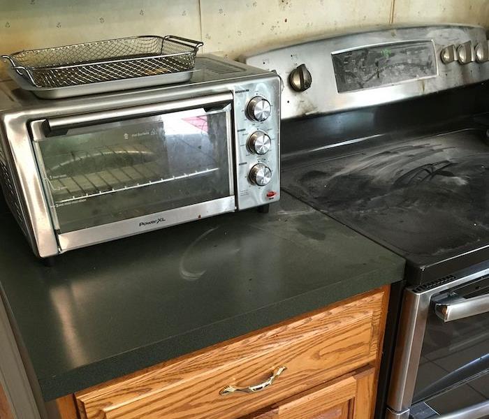 Kitchen with dirty stovetop and counters