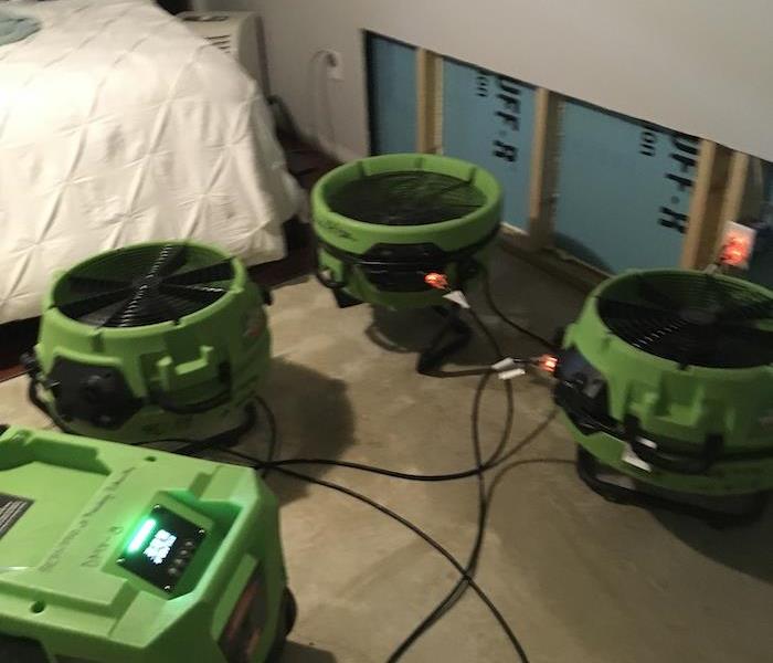 SERVPRO equipment on a concrete floor with drywall removed